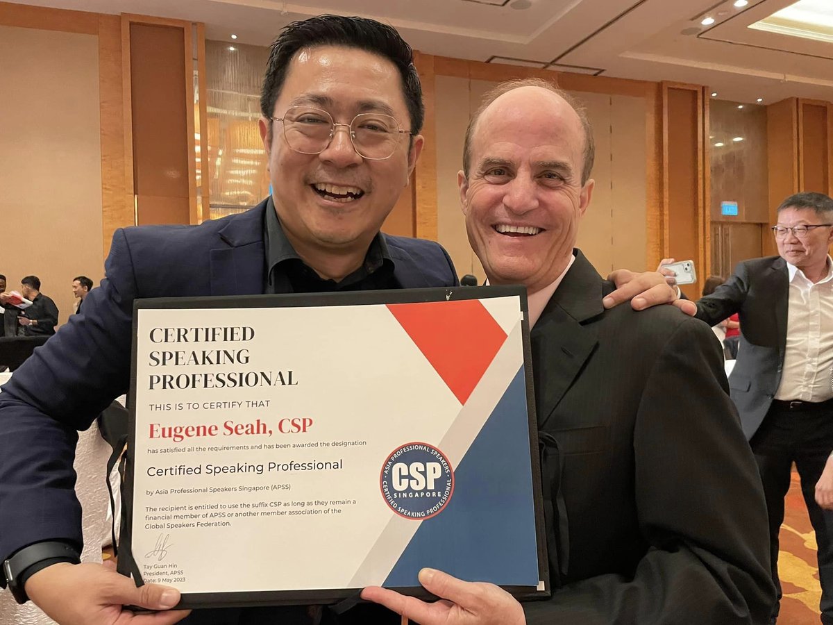 Eugene Seah holding his Certified Speaking Professional certificate