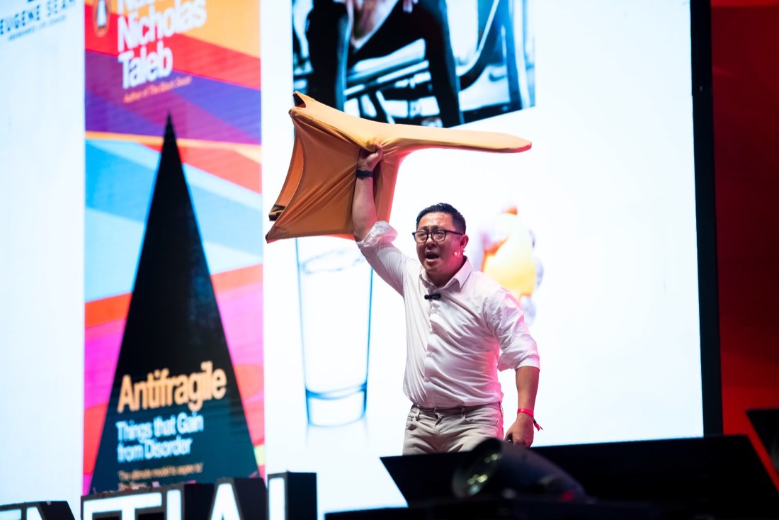 Eugene Seah on stage presenting the Antifragile keynote